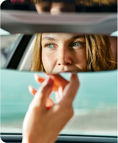 woman in a car mirror
